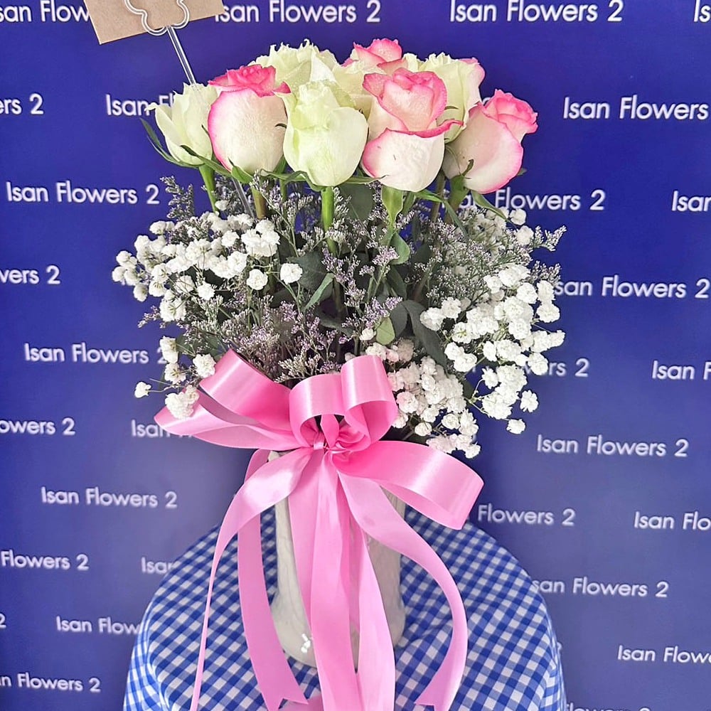 8 pink and 7 white big roses with filler in vase a